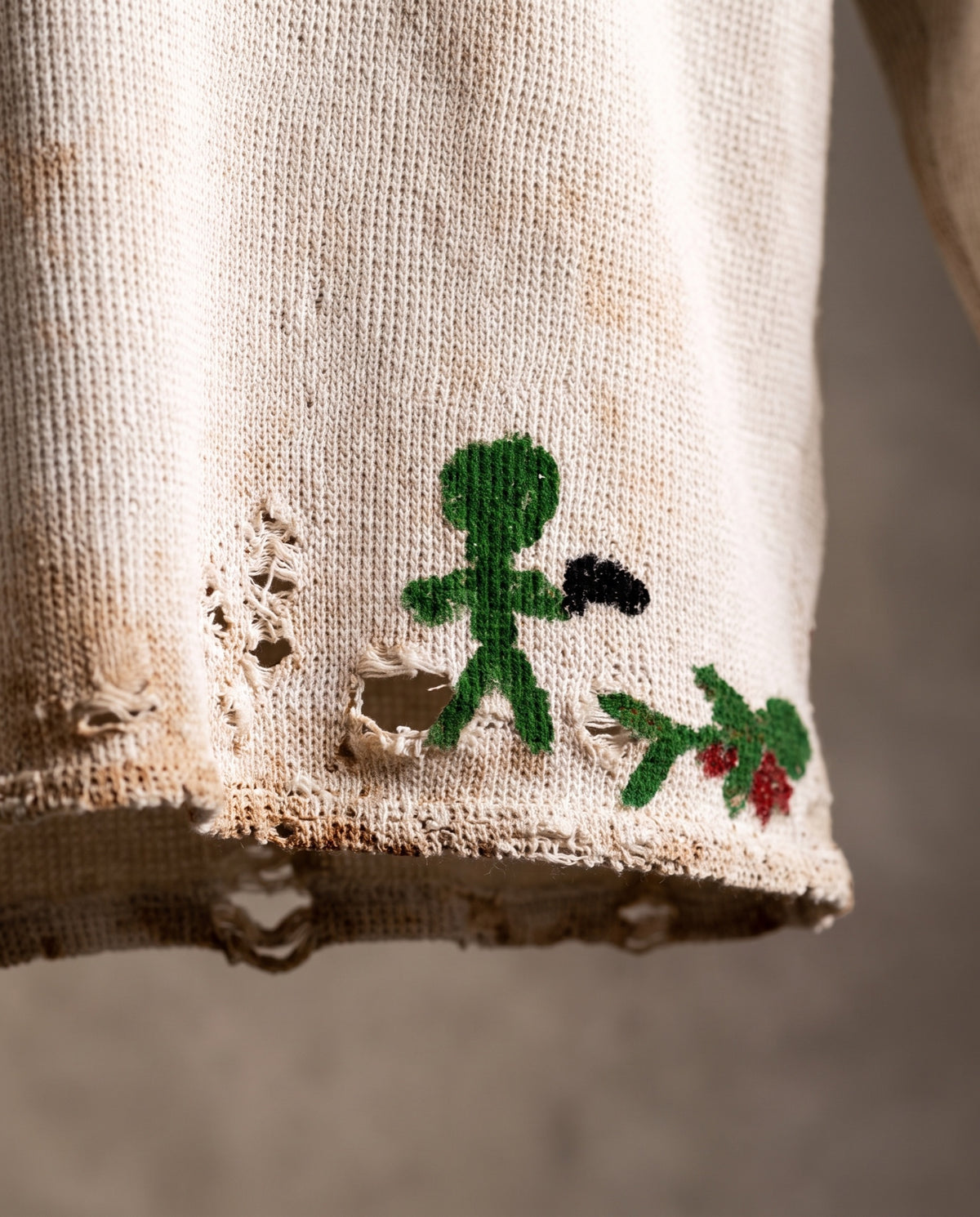 Close-up of the stick-figure graphic and distressed hem