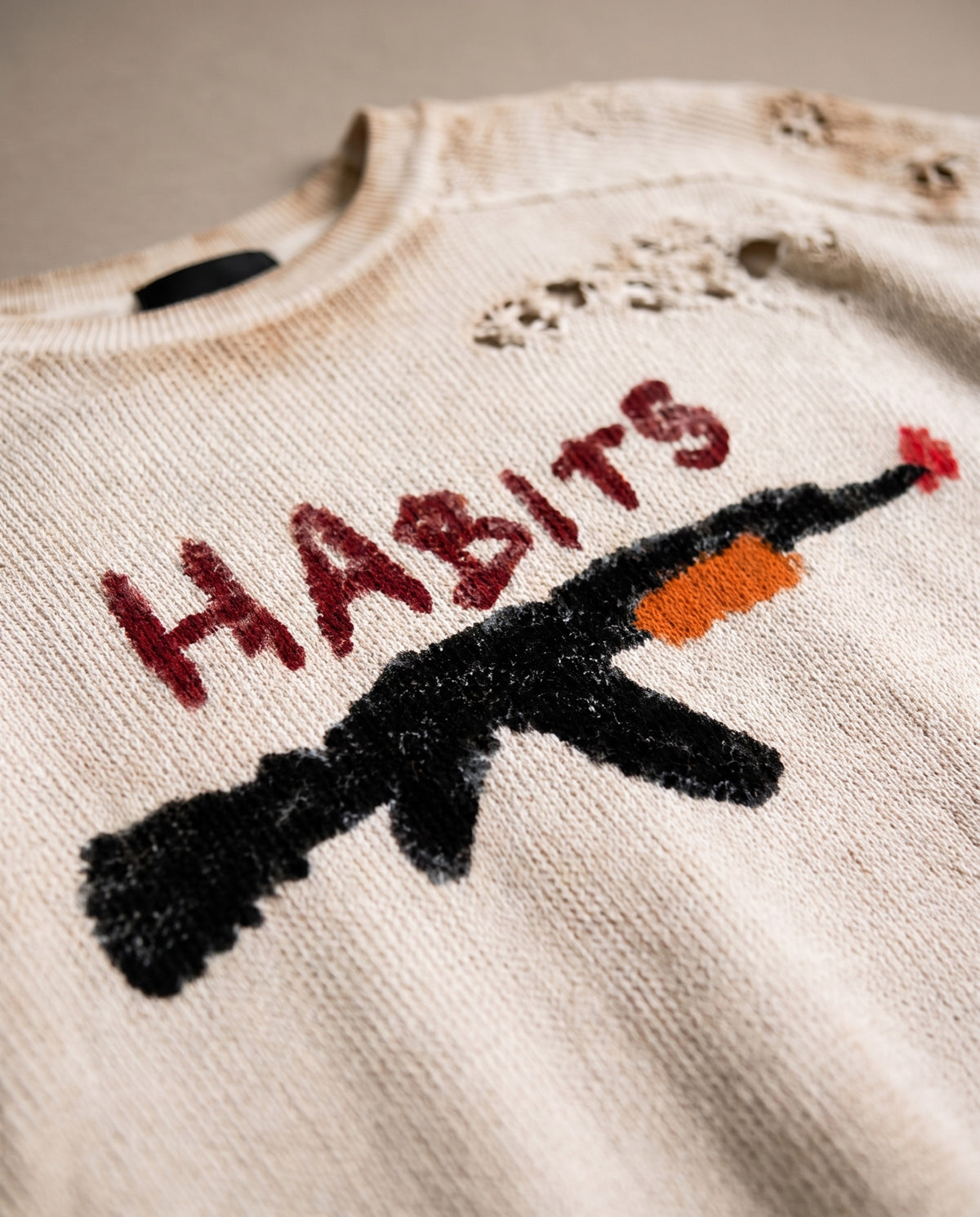 Close-up of the hand-drawn HABITS rifle print on the waffle knit